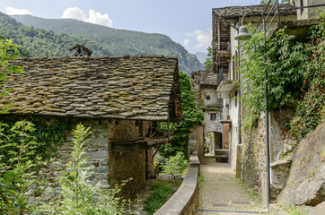 narrow passage through old houses at Fontainemore, Italy
