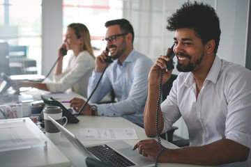 People in operations center  talking on Landline phone. Operators in the office.