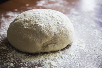 Fototapeta na wymiar Preparation for baking bread - kneading dough in your home kitchen
