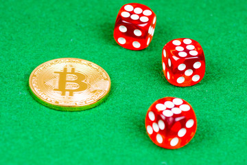 bitcoin metal coin with red dices on green cloth