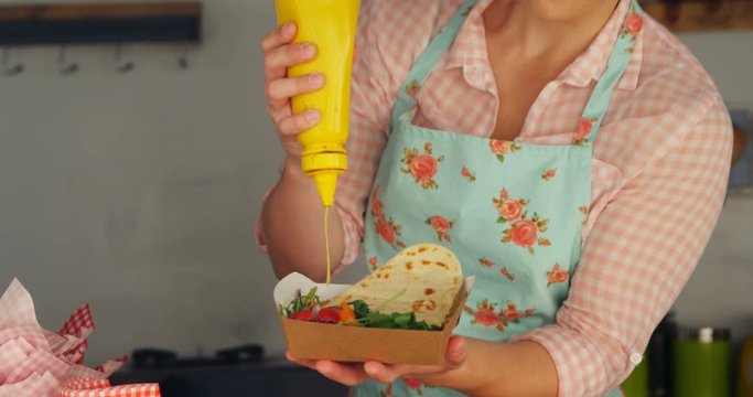 Waitress preparing meal for customer