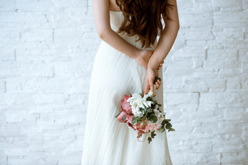 Beautiful bride is holding a wedding colorful bouquet
