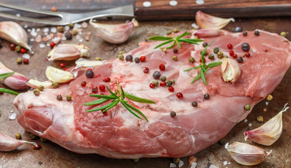 Raw lamb shoulder ready for baking with garlic, rosemary and spices. The ingredients for a delicious dinner © la_vanda