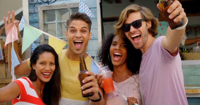 Portrait of happy friends posing with drinks