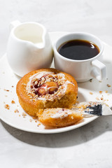 sweet cake with cream, jam and a cup of black coffee, vertical