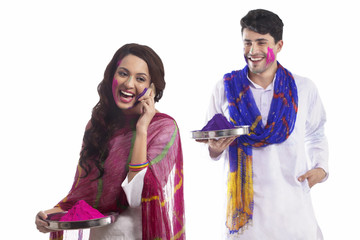 Woman with holi colour talking on a mobile phone