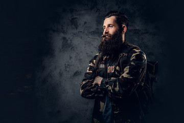 Bearded tattooed male in camouflage jacket.
