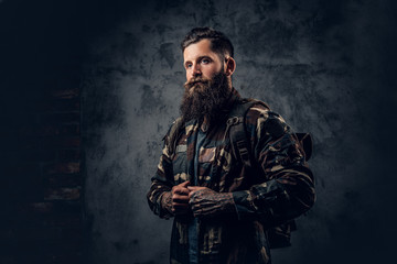 Fototapeta premium Bearded tattooed male in camouflage jacket.