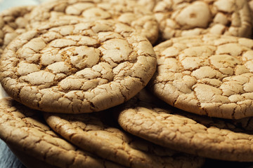 Biscuit sweet cookie background. Domestic stacked butter biscuit pattern concept,close up macro.Homemade cookies on wooden table.Cereal biscuits with the sesame,peanuts,sunflower and amaranth.