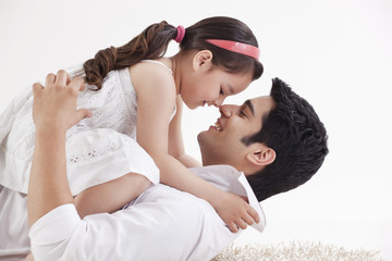 Father and daughter rubbing noses 