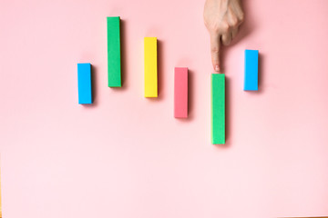 Hands working on pink desk  with colorful bar charts