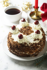 Chocolate and whipped cream cake with cherries