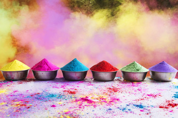 Bows of colorful Holi power arranged on floor