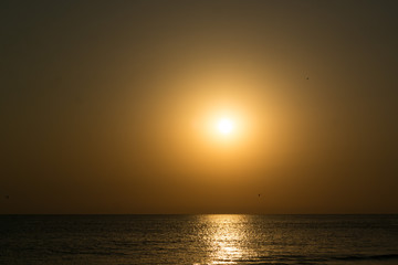Fototapeta na wymiar Phantasmagoric golden sunset on the sea