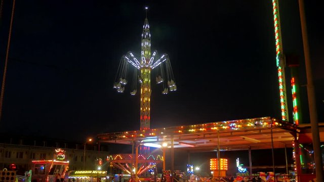 Attraction night carousel. nightlife Carnival ride in action at night game