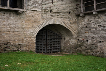 Ancient medieval wooden gate in a limestone wall