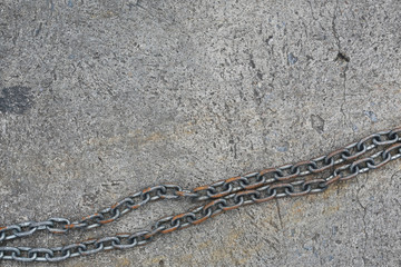Iron chain and dirty grunge cement floor background.