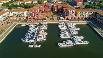 Fototapeta na wymiar Aerial view of marina with boats and yachts on port of modern residential district from above 