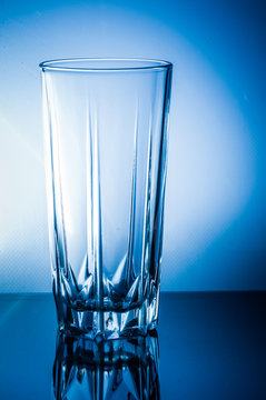 empty transparent glass on a blue background