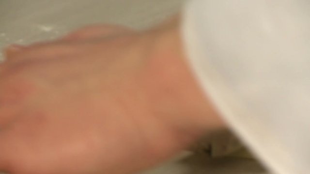 Baker rolling dough with rolling pin