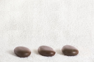 Fototapeta na wymiar Massage stones in a row on a towel 