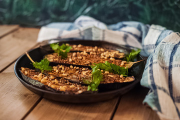 Harvest - ripe juicy eggplant. Aubergine dish. Grilled eggplant. Baked eggplants and soy sauce, honey, mustard, lemon juice, parsley and cedar nuts.