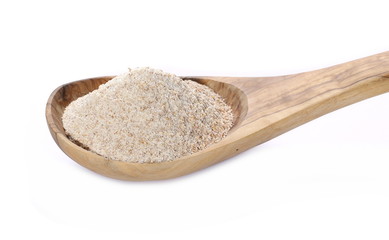 Pile of integral wheat flour in wooden spoon isolated on white