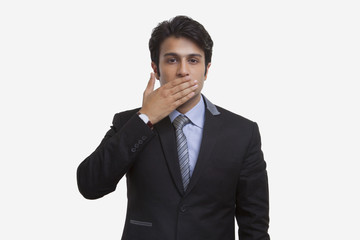 Businessman closing his mouth