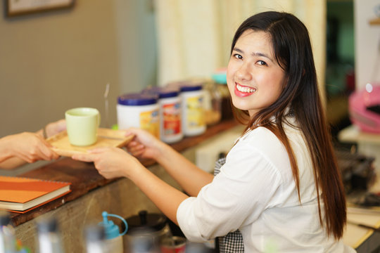 close up asian woman barista trying to preparing coffee in restaurant with waitress,startup owner concept