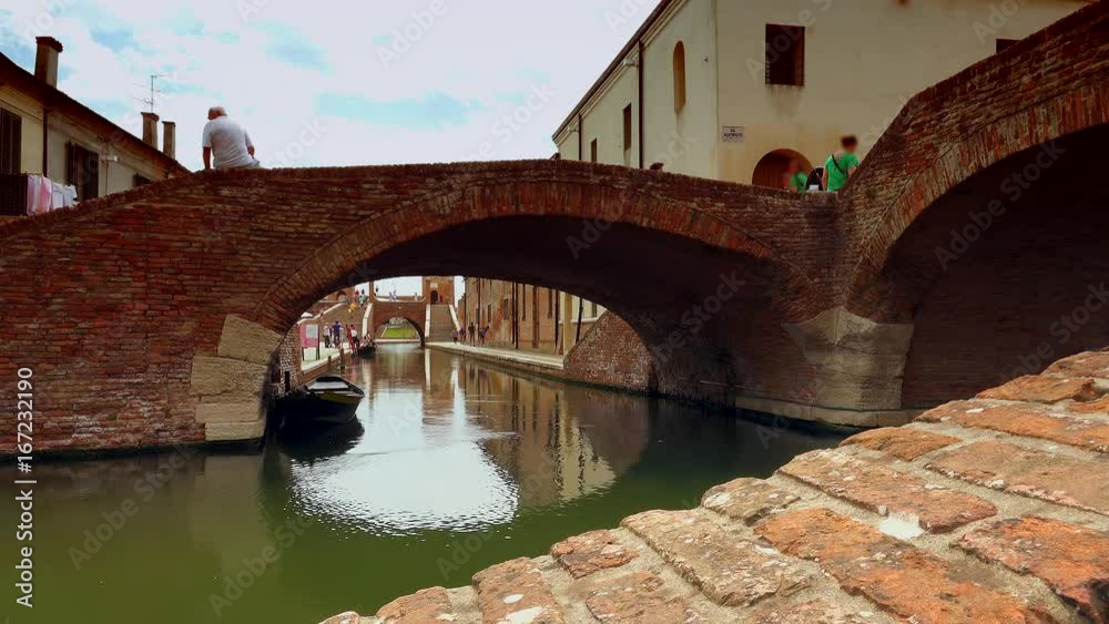 Canvas Prints Venetian feelings while water flowing under bridges of an old lagoon town near Ferrara in color graded clip