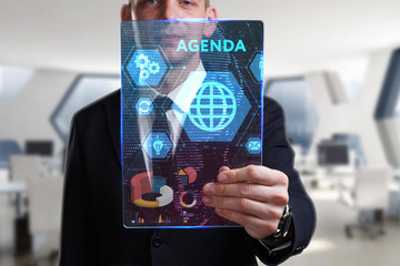 Business, Technology, Internet and network concept. Young businessman working on a virtual screen of the future and sees the inscription: Agenda