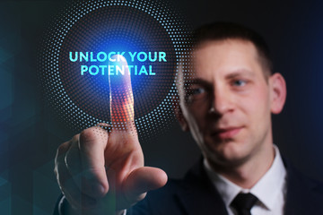 Business, Technology, Internet and network concept. Young businessman working on a virtual screen of the future and sees the inscription: Unlock your potential