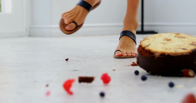 Cake falling in front of womans feet