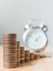 Coins stack step growing growth with time clock, Concept goal business finance or saving money, Copy space