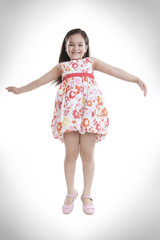 Portrait of little girl jumping in the air