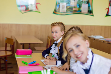 Fototapeta premium Girls at school desks