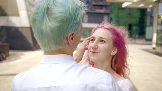 happy young couple of hipsters with dyed hair in bright colors. beautiful young people with pink and blue hair