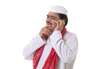 Indian politician thinking while talking on mobile phone 