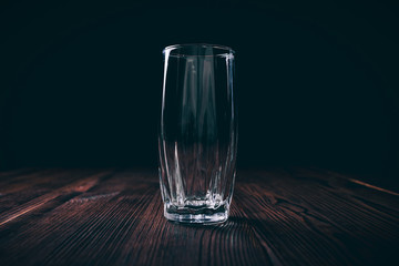Close-up of an empty faceted glass on a black background