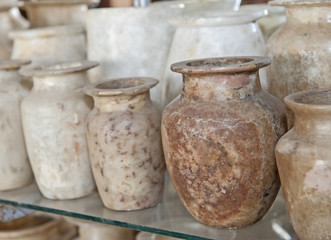 Row of alabaster vases at an egyptian market - obrazy, fototapety, plakaty