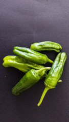 Pimientos padron. Padron peppers on dark background.