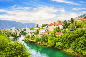 Fototapeta na wymiar A beautiful view of the old bridge across the Neretva River in Mostar, Bosnia and Herzegovina, on a sunny summer day