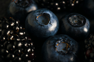 Blueberries and blackberries mix macro dark photo