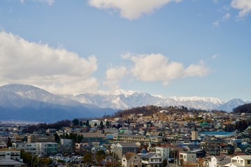 Obraz premium 北アルプスの山々を背景にする住宅街