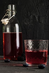 Soda water with blueberry syrup sparkling dark background photo