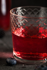 Soda water with blueberry syrup sparkling dark background photo