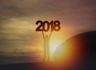 silhouette of people standing next to car for travel and number of 2018, new year background