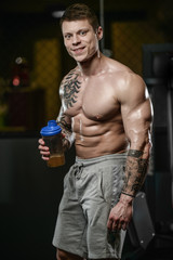 Strong and handsome athletic young tattoo man with muscles