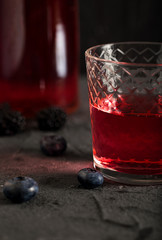 Soda water with blueberry syrup sparkling dark background photo