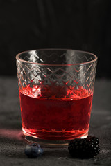 Soda water with blueberry syrup sparkling dark background photo